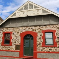 Original buildings made of the regional "red" stone from the nearby quarry.